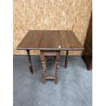 An oak drop end narrow table, upon turned legs [extended, 78cm] [height, 70cm, width, 69cm, depth,