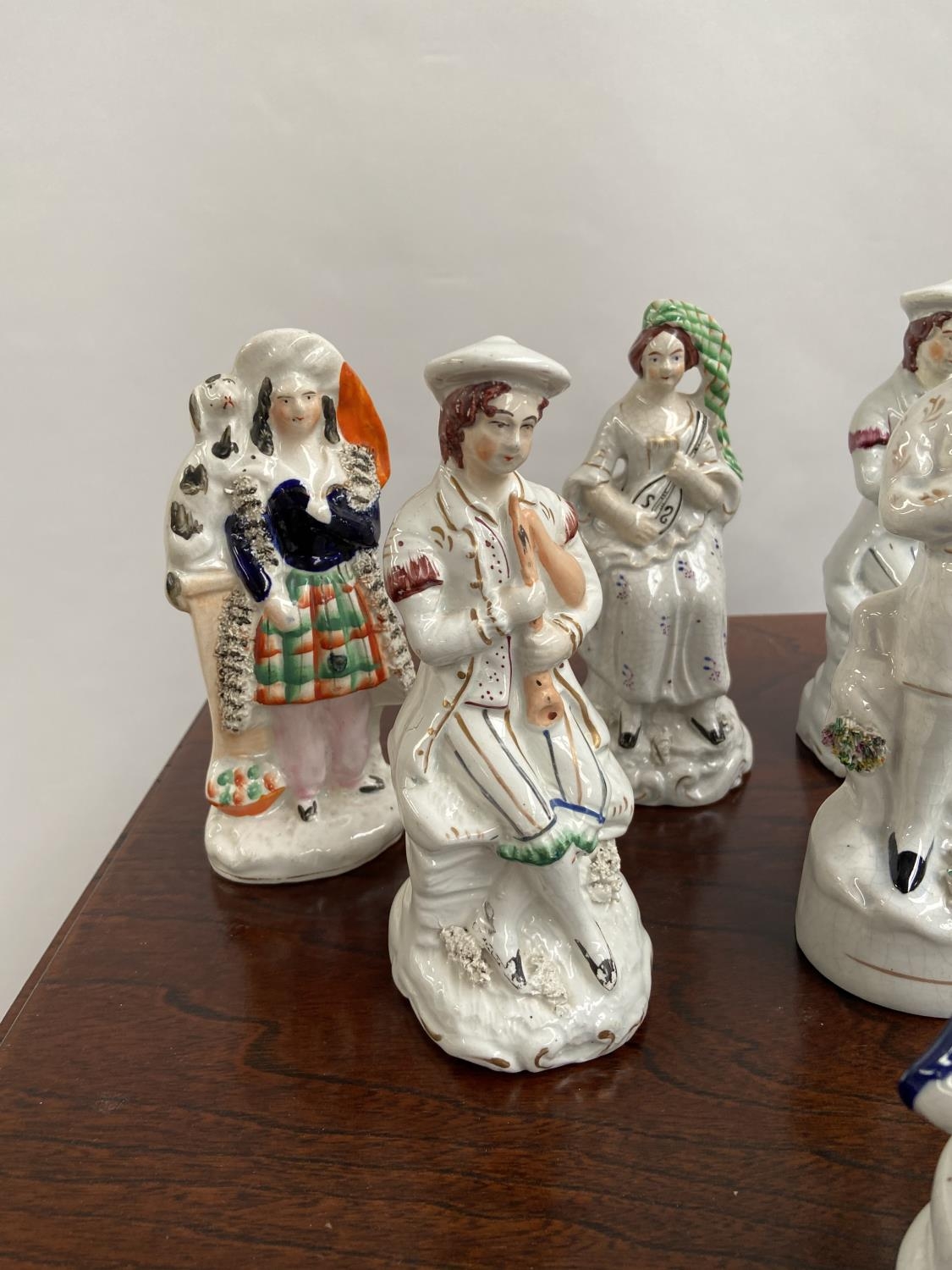 A Collection of antique Staffordshire figurines to include young girl sat upon a rams back, Asian - Image 4 of 9