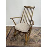 A Vintage Ercol elm wood rocking arm chair. [87x61x43cm]