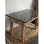 A contemporary table with single under drawer to each end and finished with a heavy granite top
