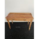 A 19th century pine two drawer console table. Designed on turned legs