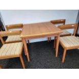 A Mid century Danish Nissen teak dining table and four matching chairs. [74x85x85cm]