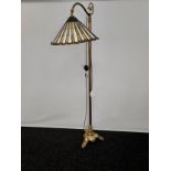 An 19th century heavy brass floor reading lamp with Tiffany style stain glass shade. Manufacturer