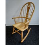 A Bespoke hand made light wood Windsor design rocking chair.