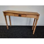 A 19th century farm house pine console table with single drawer and turned leg supports [