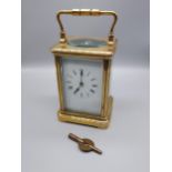 A Heavy Antique brass and bevel glass carriage clock. Comes with a key. [Runs for a short while then