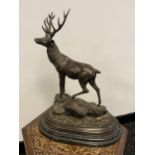 A bronze sculpture of a stag fitted on a marble base signed by Mene. [41cm in height]