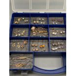A Plastic box containing a collection of 9ct gold earrings, Includes diamond and sapphire set,