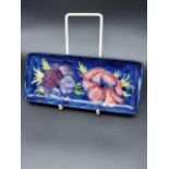 A Moorcroft Hibiscus pattern pen tray. [21x9.5cm]