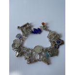 A silver charm bracelet fitted with 23 various silver chains, includes silver & enamel charms [