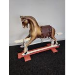 A 19th century childrens wooden rocking horse. Designed with glass marble eyes. Showing original