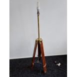 A Contemporary wood and brass tripod floor lamp. [In a working order]