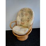 A Retro bamboo egg chair with cushions