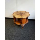 A Vintage mahogany revolving side table, designed with a pie crust edge top and queen anne legs.
