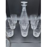 A Stylish Antique facet cut decanter with 8 matching glasses. Together with an etched decanter.