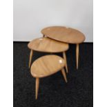 A Set of three vintage Ercol pebble tables. Showing blue sticker to the base and in a light elm