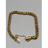 A 14ct gold curb bracelet set with a single diamond. 0.21ct diamond. [16cm in length][8.75grams]