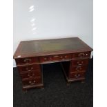 An Antique style knee hole writing desk with green leather top. [78x122x60cm]