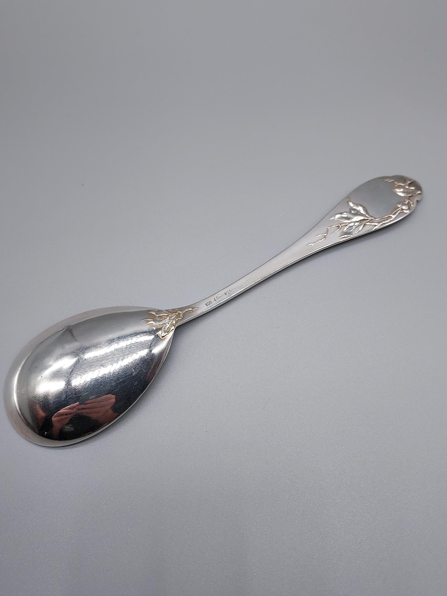 A German 800 Silver marked desert spoon, Designed with a raised relief bird eating berries. [19. - Image 2 of 4