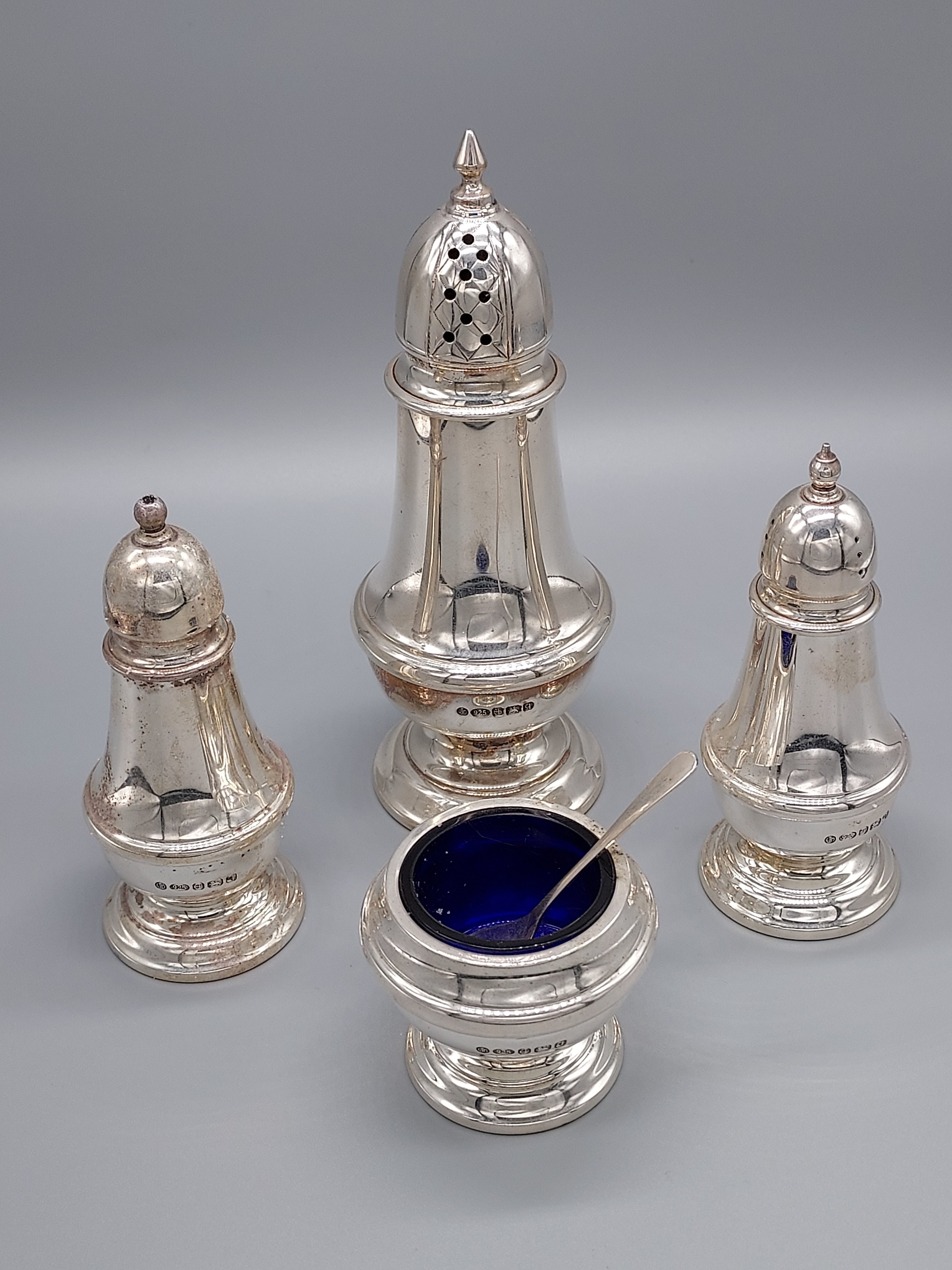 A Lot of four Birmingham silver condiment items. Includes Sugar Shaker, Salt and Pepper pot and