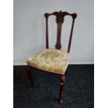 A 19th century ornate carved back parlour chair. Supported on cabriole legs.