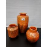 Three Pilkington Royal Lancastrian orange drip glaze 'flame design' vases. [Tallest 26cm]