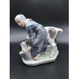 A Royal Copenhagen figurine Girl with Calf. [16cm in height]