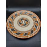 A Charlotte Rhead Crown Ducal wall charger. Orange chain pattern. [32cm in diameter]