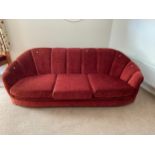 An Art Deco three seat sofa upholstered in a red material.