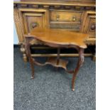 A half moon console table with decorative carved legs.