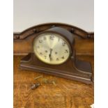 A antique junghans mantle clock comes with key and pendulum in working condition