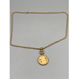 1980 Proof half sovereign within an ornate 9ct gold mount pendant. Together with a 9ct gold rope