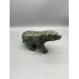 An Inuit hand carved running bear sculpture made from green hardstone. Signed Johnny Kilabuk 2011