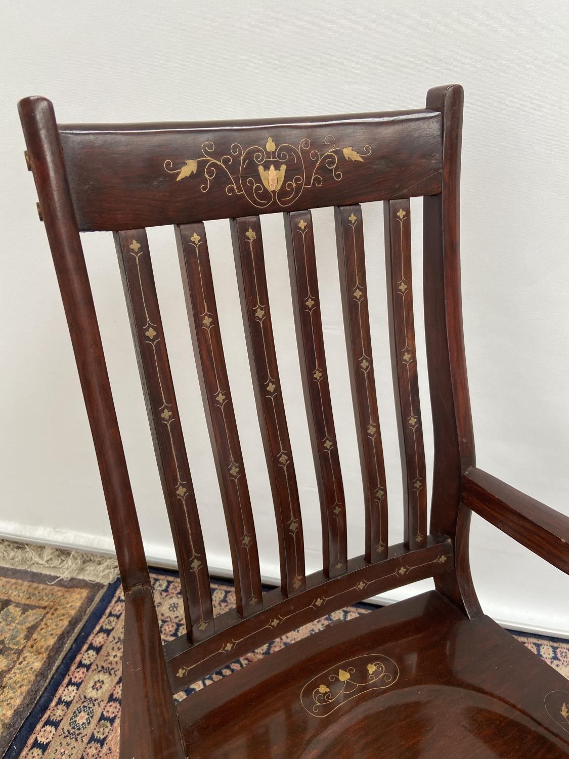 A Hardwood and brass inlaid rocking arm chair. [80x50x40cm] Originally from Saudi Arabia. - Image 2 of 3