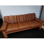 A 1960's mid century Ekornes three seat sofa. Designed with teak wooden frame and brown leather