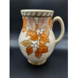 A Charlotte Rhead Crown Ducal 'Golden Leaves pattern' water jug. [22cm in height]