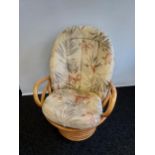 A Retro bamboo egg chair with cushions