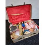 A Case containing a collection of vintage dolls and clothing.