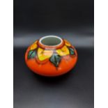 A Poole pottery bulbous orange glaze vase. [10cm in height]