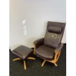 An Ercol brown leather and light wood relaxer arm chair with matching stool.