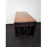 A 19th century drop end dining table, supported on 6 turned legs. [73x153x107cm]