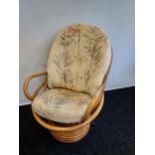 A Retro bamboo egg chair with cushions