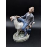 A Royal Copenhagen figurine boy riding a goat. [19cm in height]