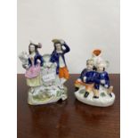 Two various antique Staffordshire figurines to include clock design couple figurine and two gents
