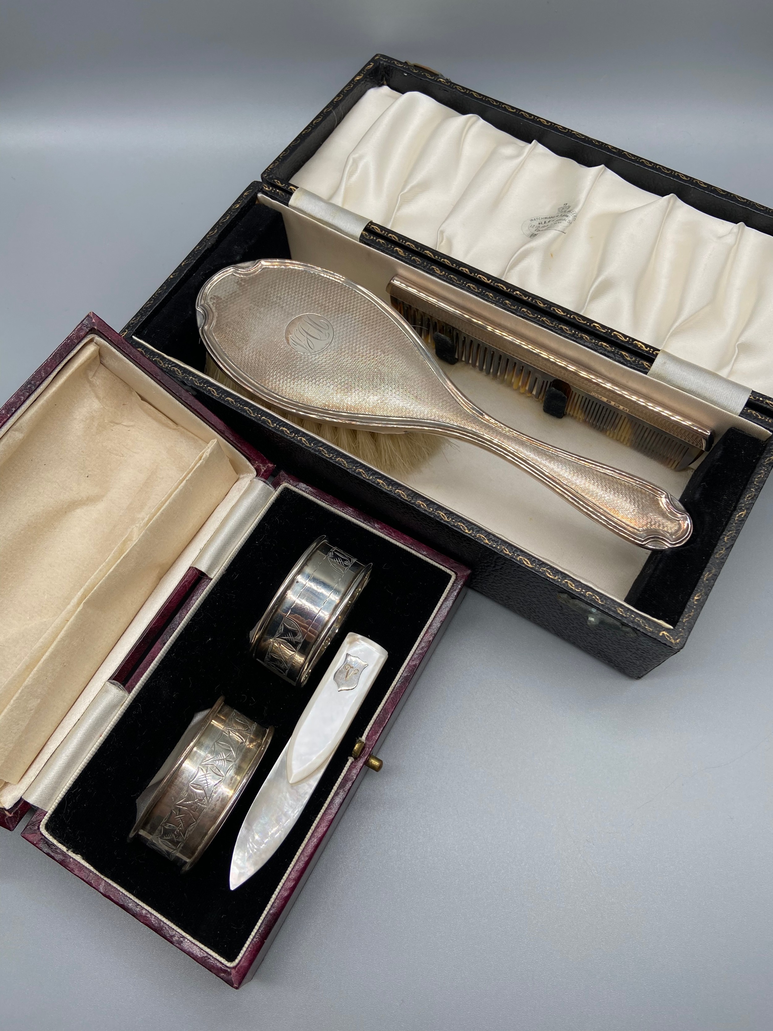 A Birmingham silver napkin ring set, Birmingham silver brush and comb set and a mother of pearl book