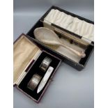 A Birmingham silver napkin ring set, Birmingham silver brush and comb set and a mother of pearl book