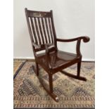 A Hardwood and brass inlaid rocking arm chair. [80x50x40cm] Originally from Saudi Arabia.