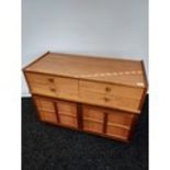 A Mid century teak four drawer, two door cabinet. [74x102x44cm]