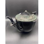 A 19th century Jackfield black and floral design double spout tea pot. [18cm in height]