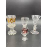 A Lot of four antique and vintage cut glass drinking glasses. Includes Bohemian orange tinted and